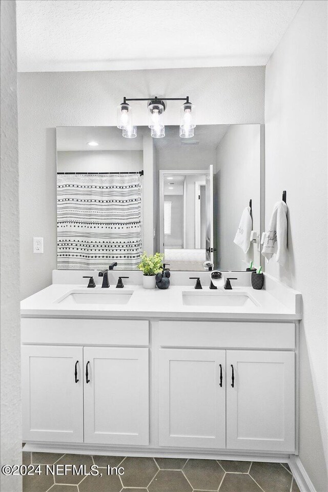 bathroom featuring double sink vanity and tile patterned flooring