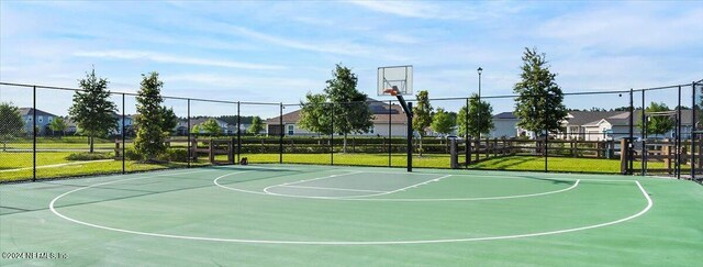 view of basketball court featuring a lawn