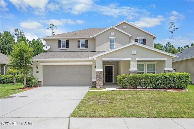 view of front of property with a garage and a front yard