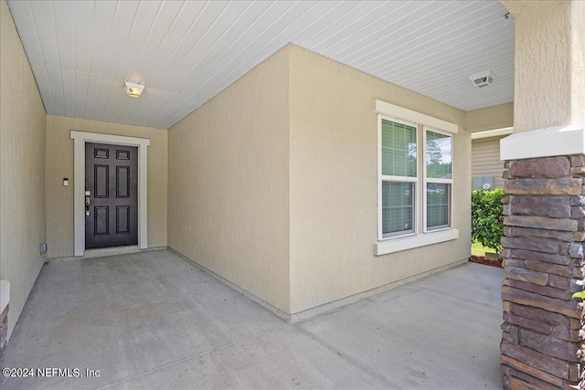 doorway to property with a patio area