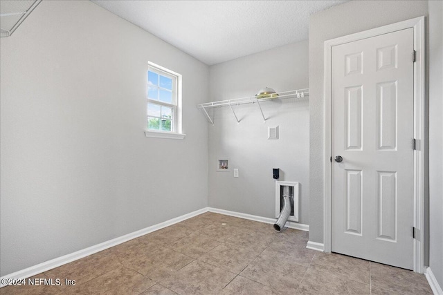 clothes washing area featuring light tile patterned floors and hookup for a washing machine