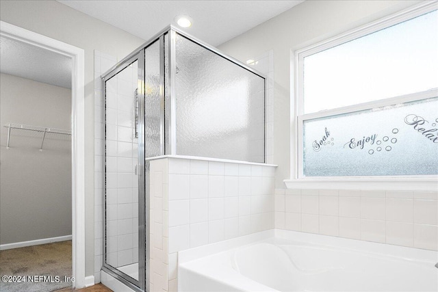 bathroom with shower with separate bathtub