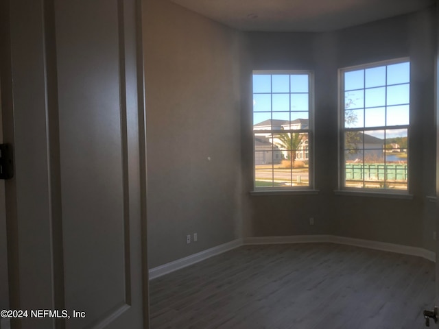 unfurnished room with hardwood / wood-style flooring