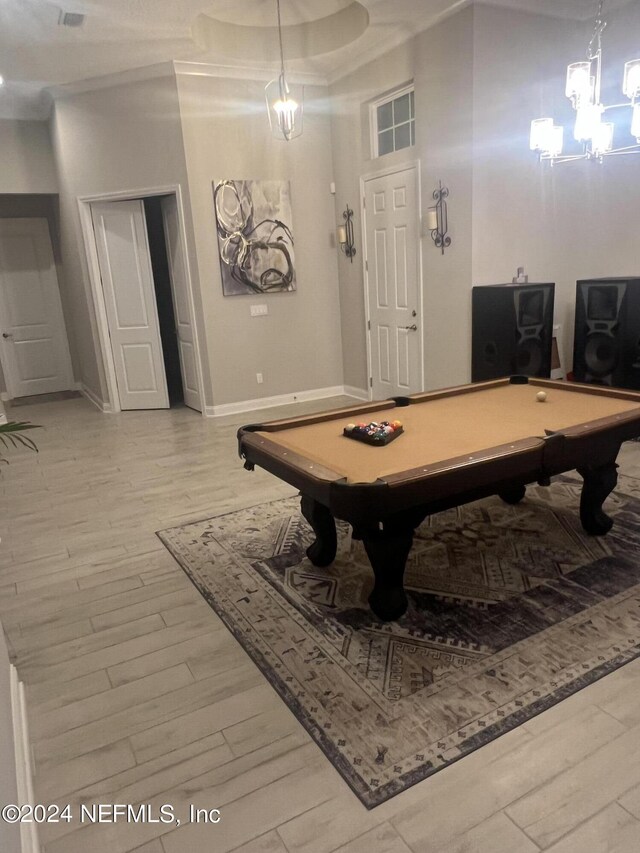 playroom featuring hardwood / wood-style floors, an inviting chandelier, and pool table