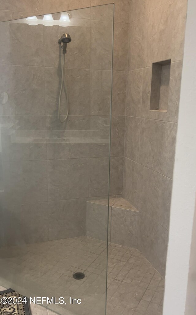 bathroom with a tile shower