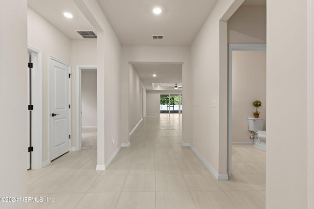 hall with light tile patterned floors