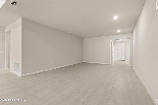 spare room with a textured ceiling