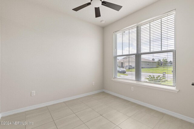 spare room with light tile patterned floors and ceiling fan