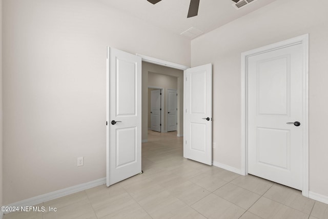 unfurnished bedroom featuring light tile patterned floors and ceiling fan