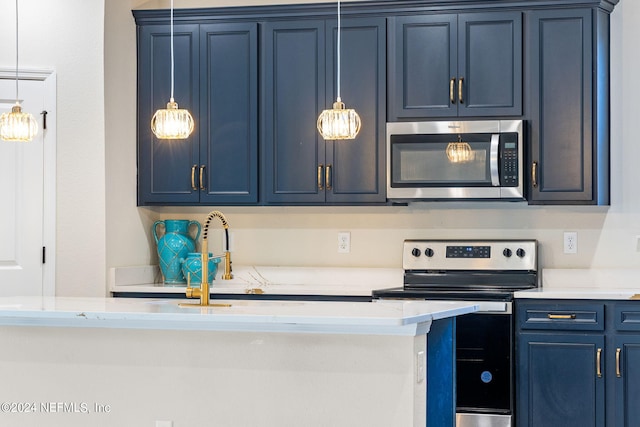 kitchen with blue cabinetry, appliances with stainless steel finishes, and sink