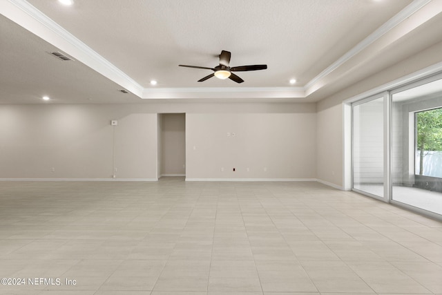 unfurnished room with crown molding, ceiling fan, and a tray ceiling