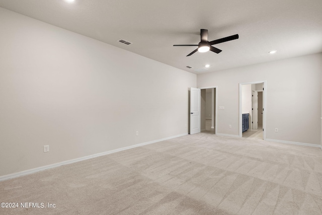 spare room featuring light colored carpet and ceiling fan