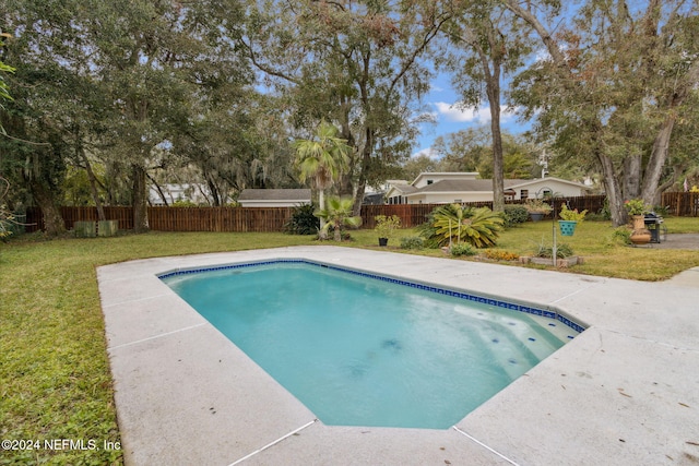 view of swimming pool featuring a lawn and a patio area