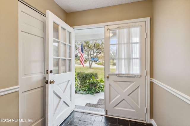 entryway with a textured ceiling