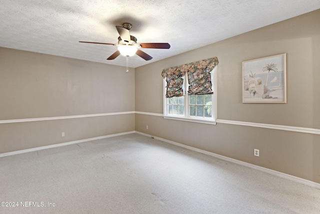 spare room featuring a textured ceiling, carpet floors, and ceiling fan