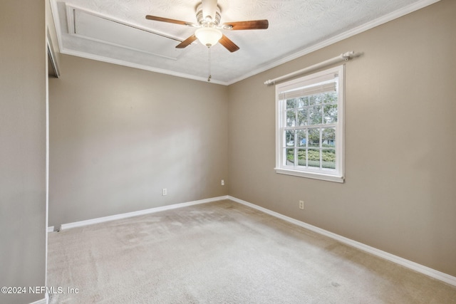 carpeted spare room featuring ceiling fan, a textured ceiling, and ornamental molding