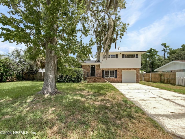 view of front of home featuring solar panels, a garage, and a front lawn