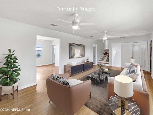 living room featuring hardwood / wood-style flooring and ceiling fan