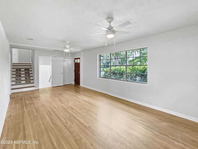 unfurnished living room with light hardwood / wood-style floors and ceiling fan