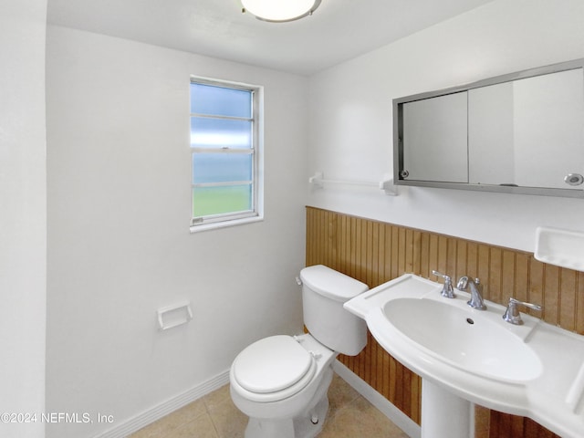 bathroom featuring toilet and tile patterned flooring