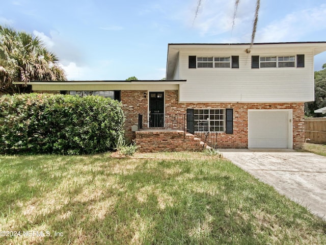 split level home featuring a garage and a front lawn