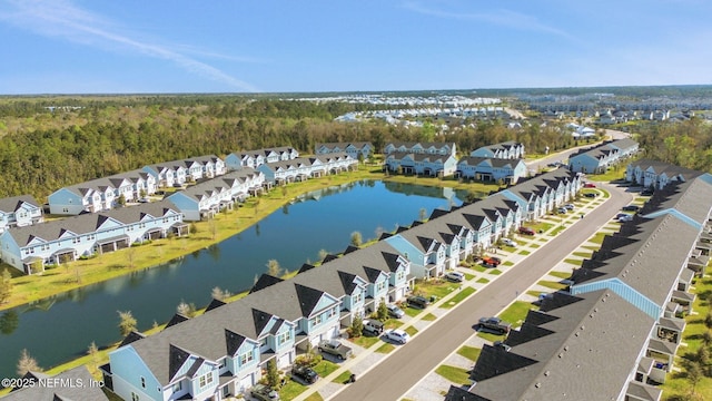 drone / aerial view featuring a residential view and a water view