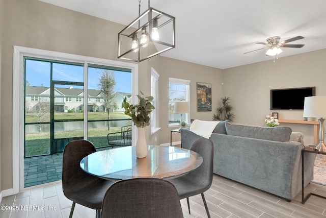 dining room featuring a ceiling fan and wood finish floors