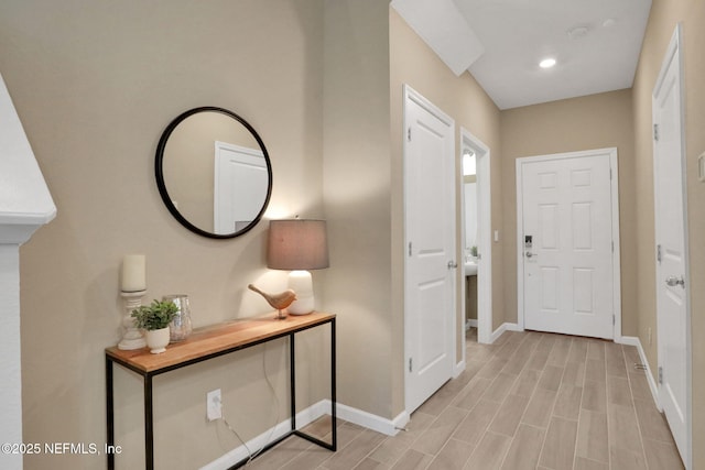 entrance foyer with wood finish floors, recessed lighting, and baseboards