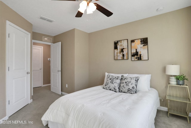 carpeted bedroom featuring visible vents, ceiling fan, and baseboards