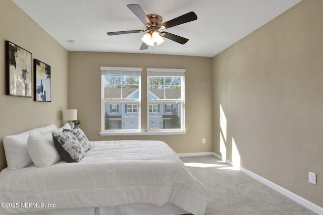 bedroom with carpet flooring, ceiling fan, and baseboards