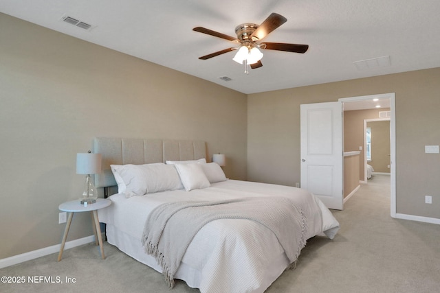 bedroom featuring ceiling fan, light colored carpet, visible vents, and baseboards