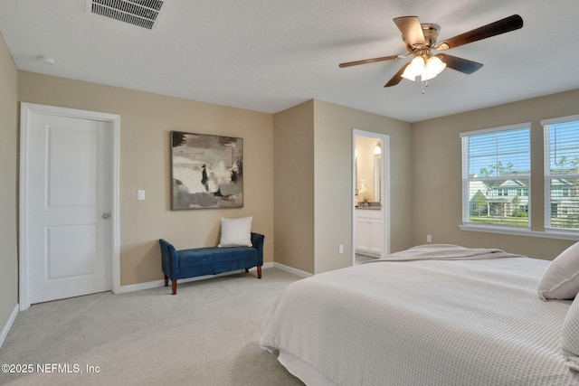 bedroom featuring visible vents, baseboards, light colored carpet, and a ceiling fan