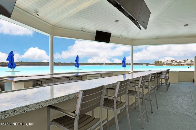 view of patio / terrace featuring outdoor wet bar and a water view