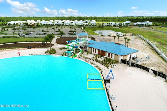 view of swimming pool featuring a residential view and a water view