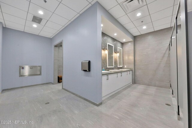 bathroom with visible vents, a paneled ceiling, and vanity