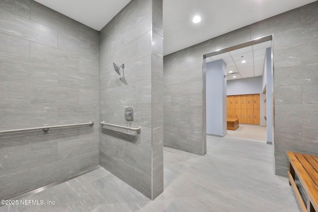 full bath featuring tile walls, recessed lighting, and a walk in shower