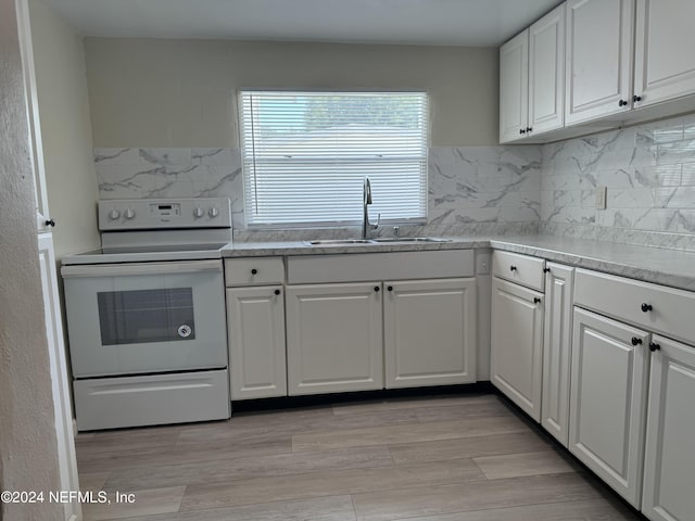 kitchen featuring white cabinetry, light hardwood / wood-style floors, backsplash, electric stove, and sink