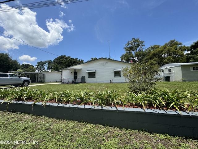 view of side of property with a yard