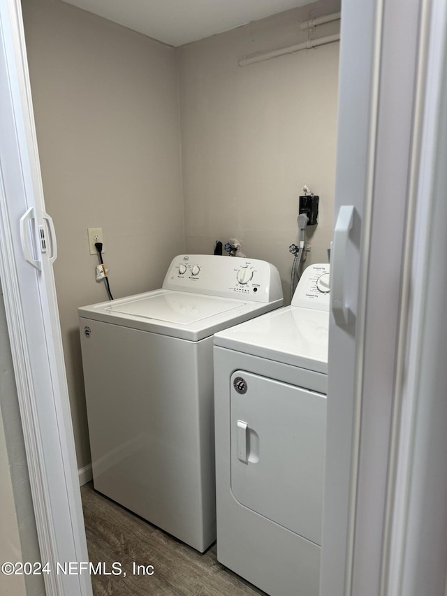 washroom featuring independent washer and dryer and hardwood / wood-style floors