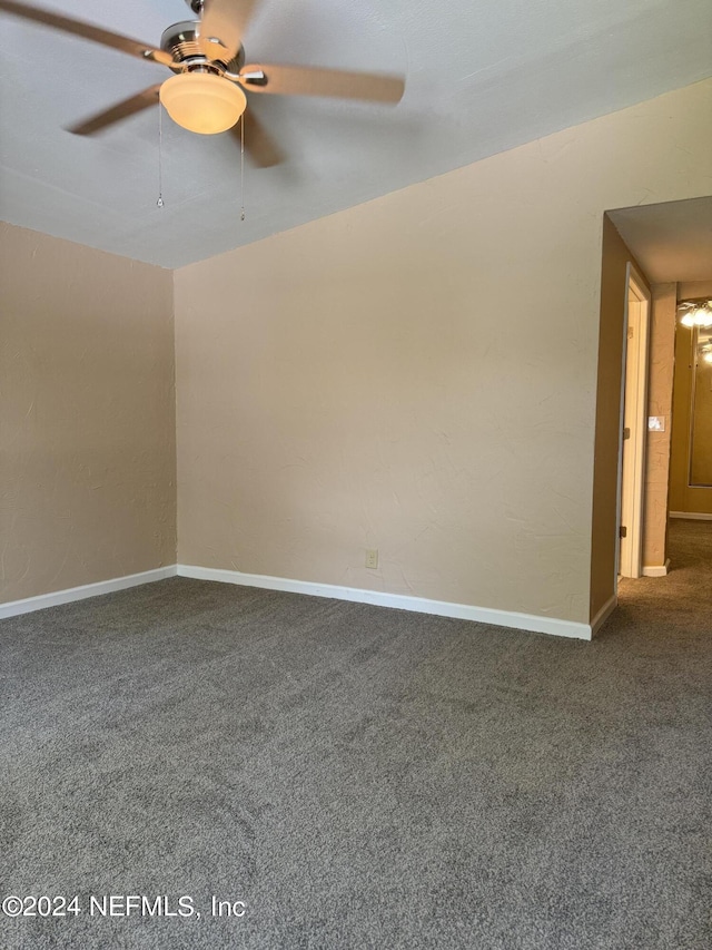 empty room with ceiling fan and carpet floors