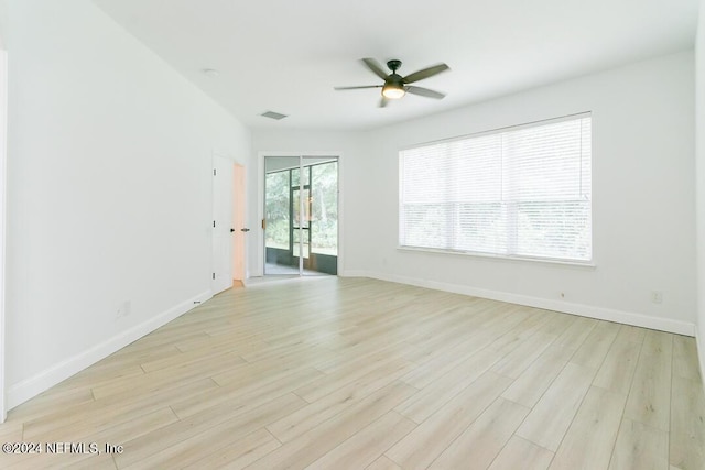 empty room with ceiling fan and light wood-type flooring