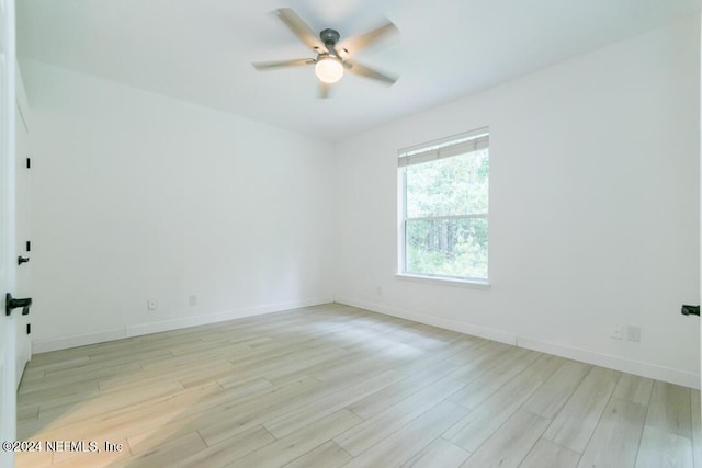 spare room featuring ceiling fan and light hardwood / wood-style flooring