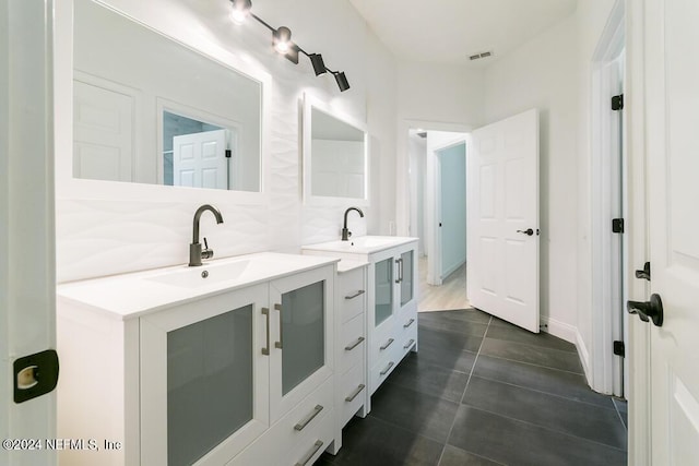 bathroom with tasteful backsplash, vanity, and tile patterned floors