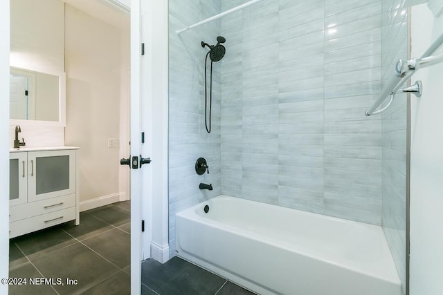 bathroom featuring tile patterned flooring, vanity, and tiled shower / bath