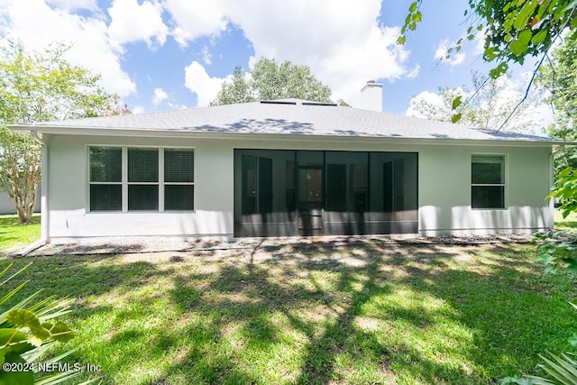 back of house featuring a yard