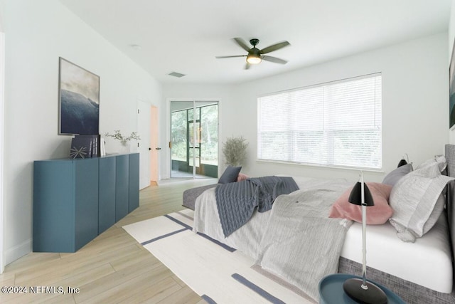 living room featuring ceiling fan and light hardwood / wood-style floors