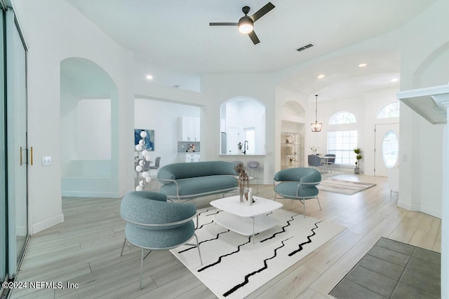 living room with sink, vaulted ceiling, and ceiling fan