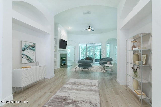 living room with ceiling fan and light wood-type flooring