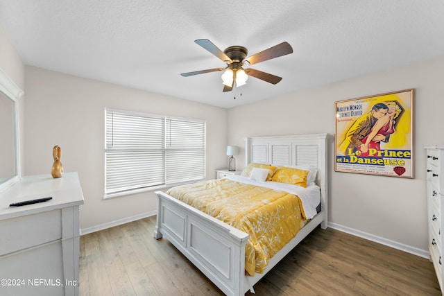 bedroom with a ceiling fan, light wood-style flooring, and baseboards