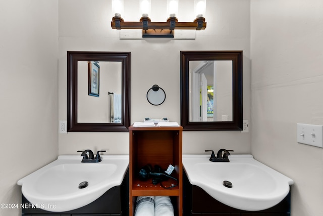 bathroom featuring two vanities and a sink